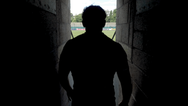 Cornish Pirates captain walking on to their home stadium rugby pitch
